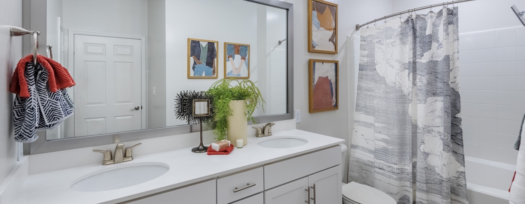 a bathroom with a sink, toilet and a mirror