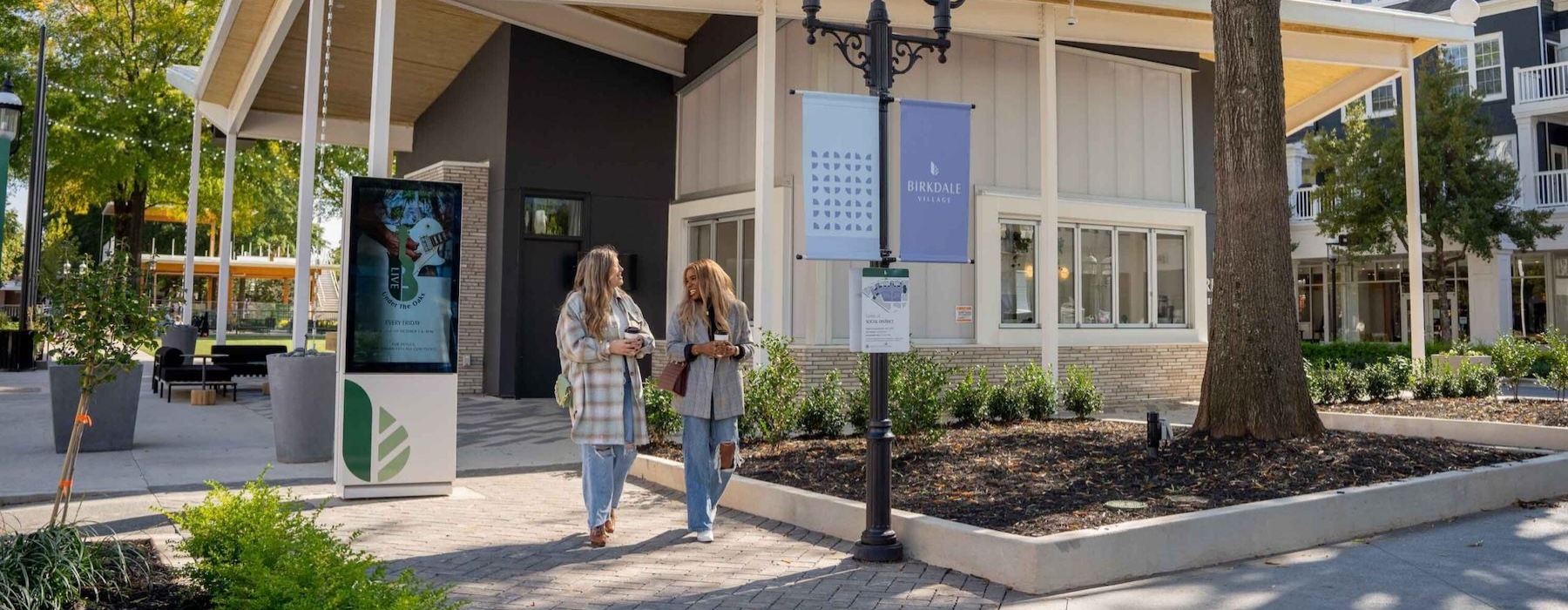 a couple of women standing outside a building