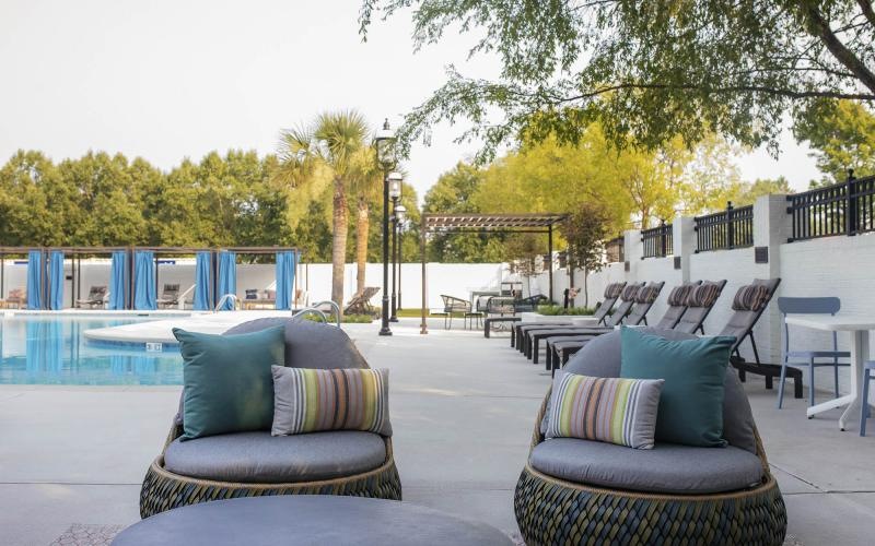 a patio with chairs and a pool