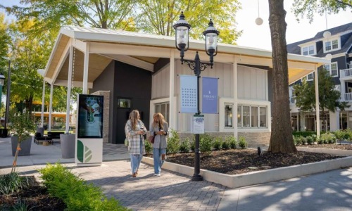 a couple of women standing outside a building